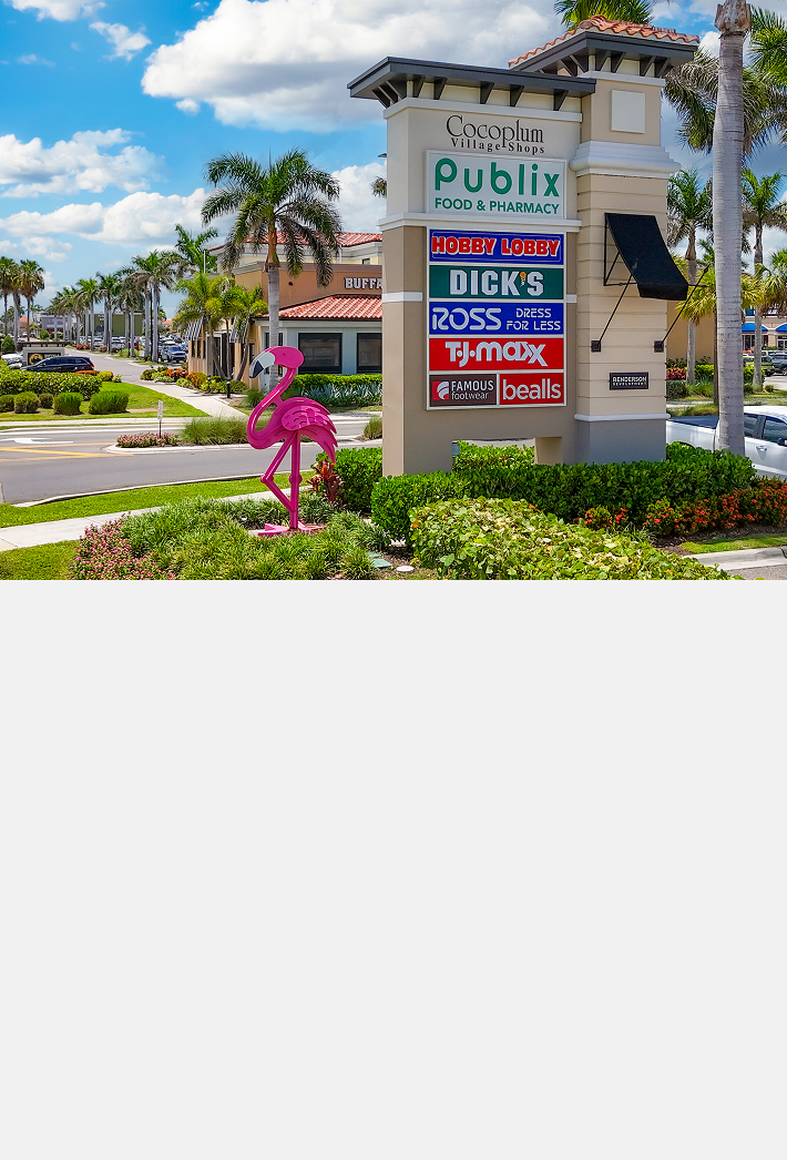 Cocoplum Village Shops signage with flamingo sculpture
